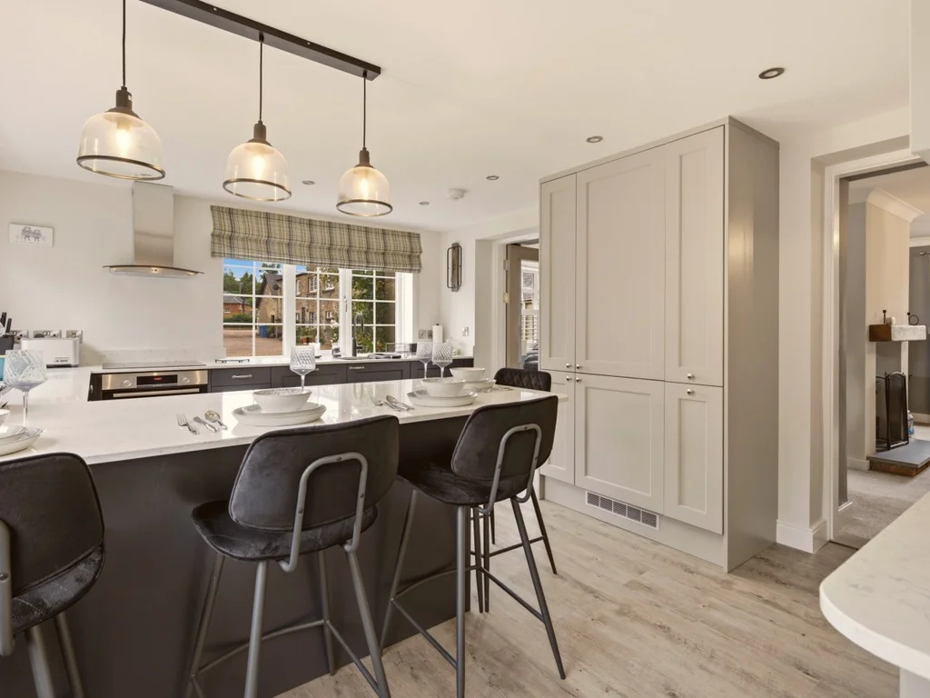Spacious kitchen island with breakfast seating and contemporary pendant lighting