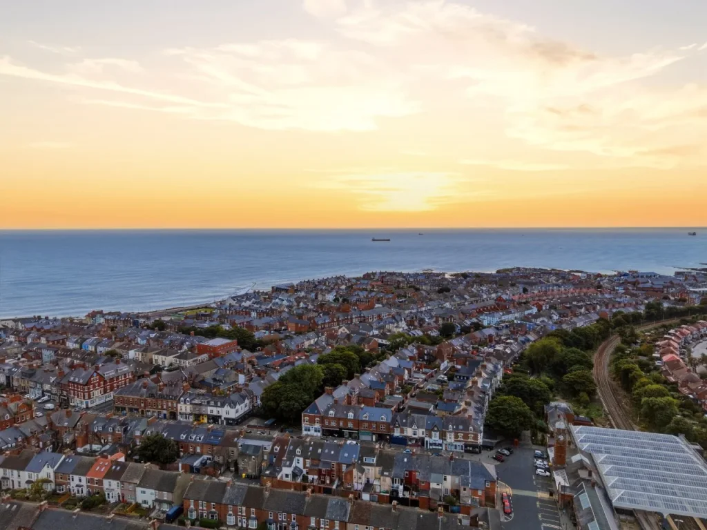 Aerial sunset view across Whitley Bay rooftops towards the coastline