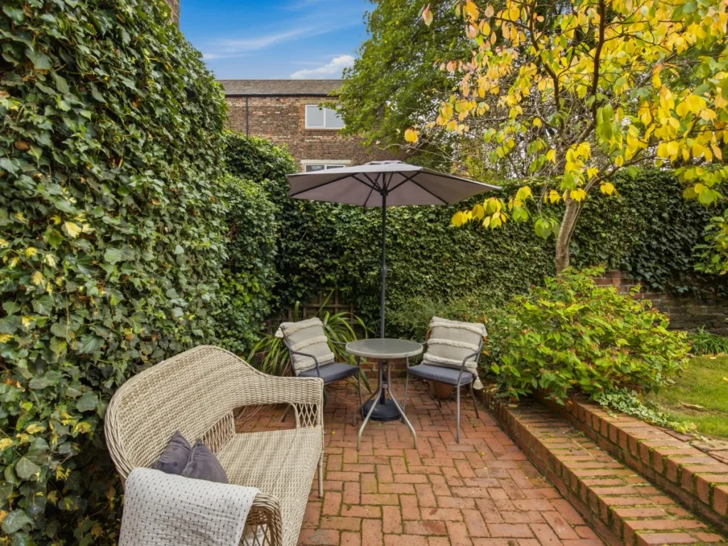 Private garden patio surrounded by mature greenery
