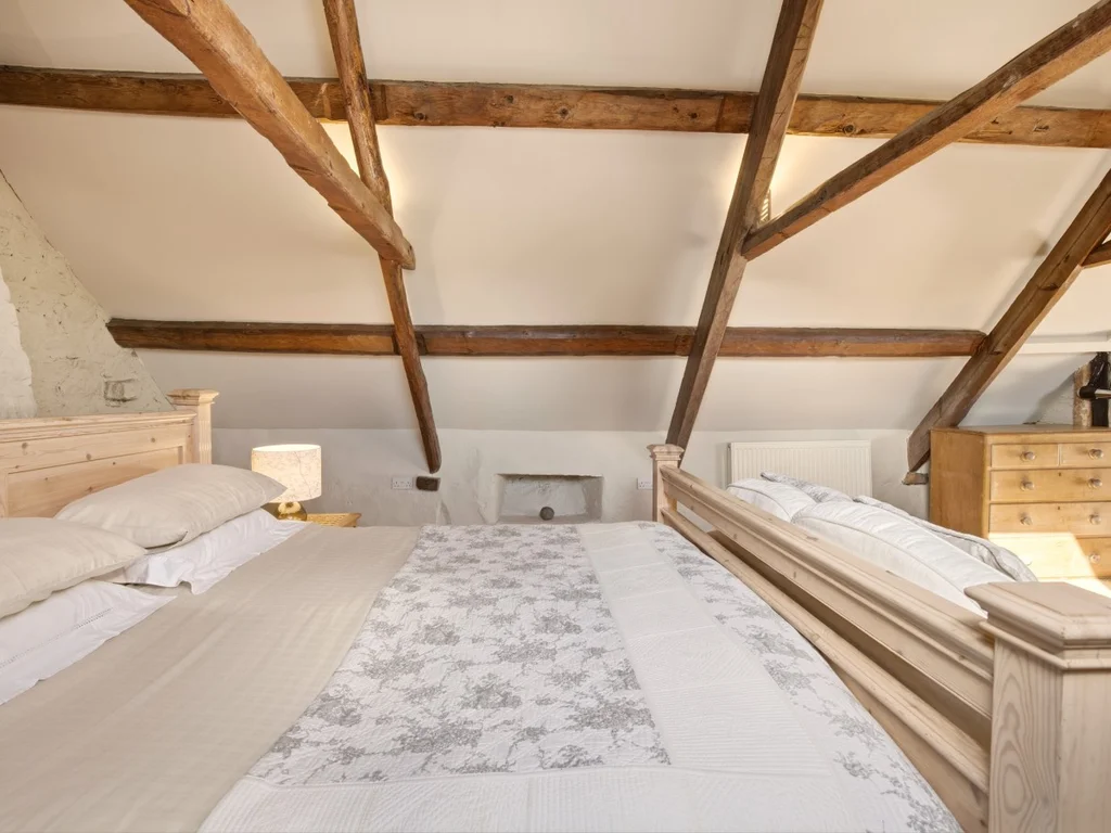 Main bedroom with a super king bed beneath original roof beams