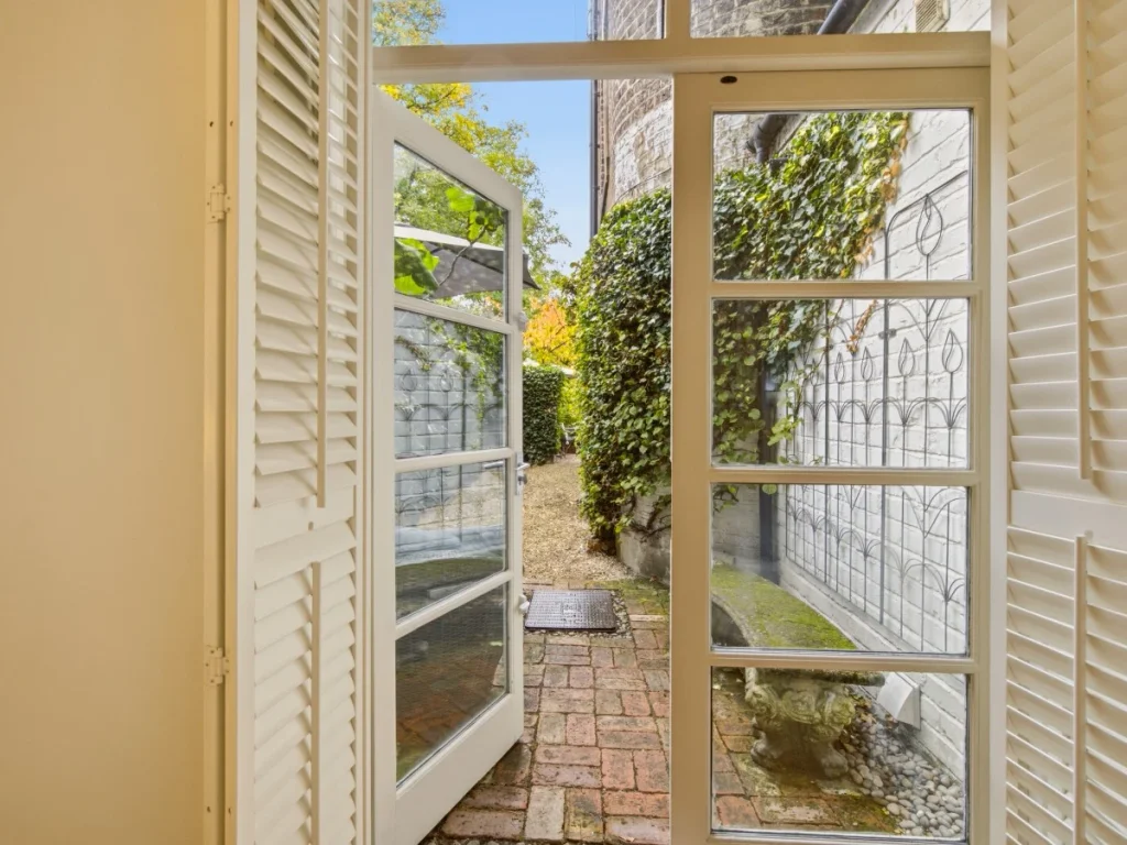 French doors open from the bedroom onto the private garden and patio