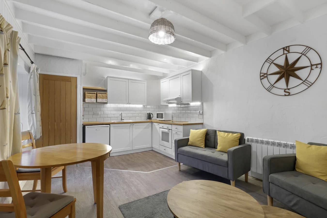 Open-plan layout connecting the lounge, dining space and kitchen