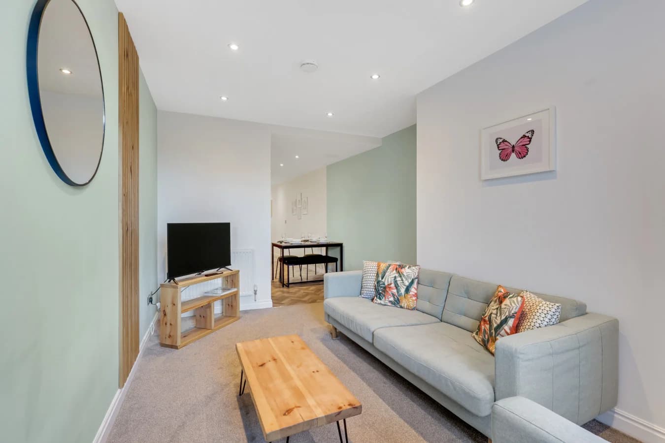 Bright living area featuring comfortable seating and calming neutral décor