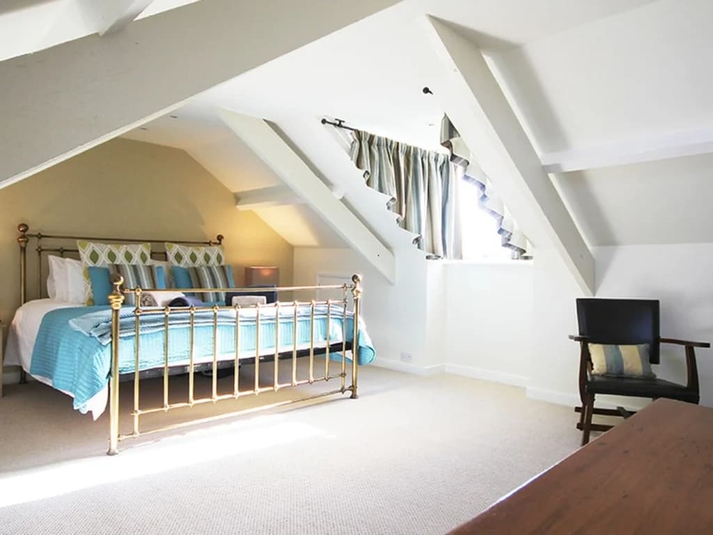 Bright super king bedroom with charming character and ample space.