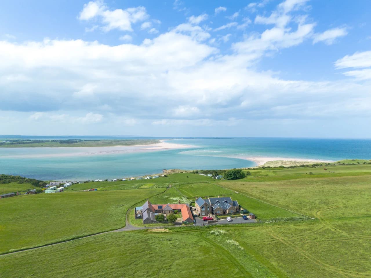 Aerial view of the cottage overlooking Budle Bay
