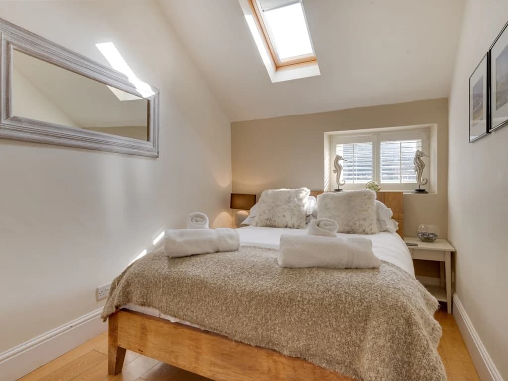 Cosy queen bedroom with skylights and plenty of natural light.