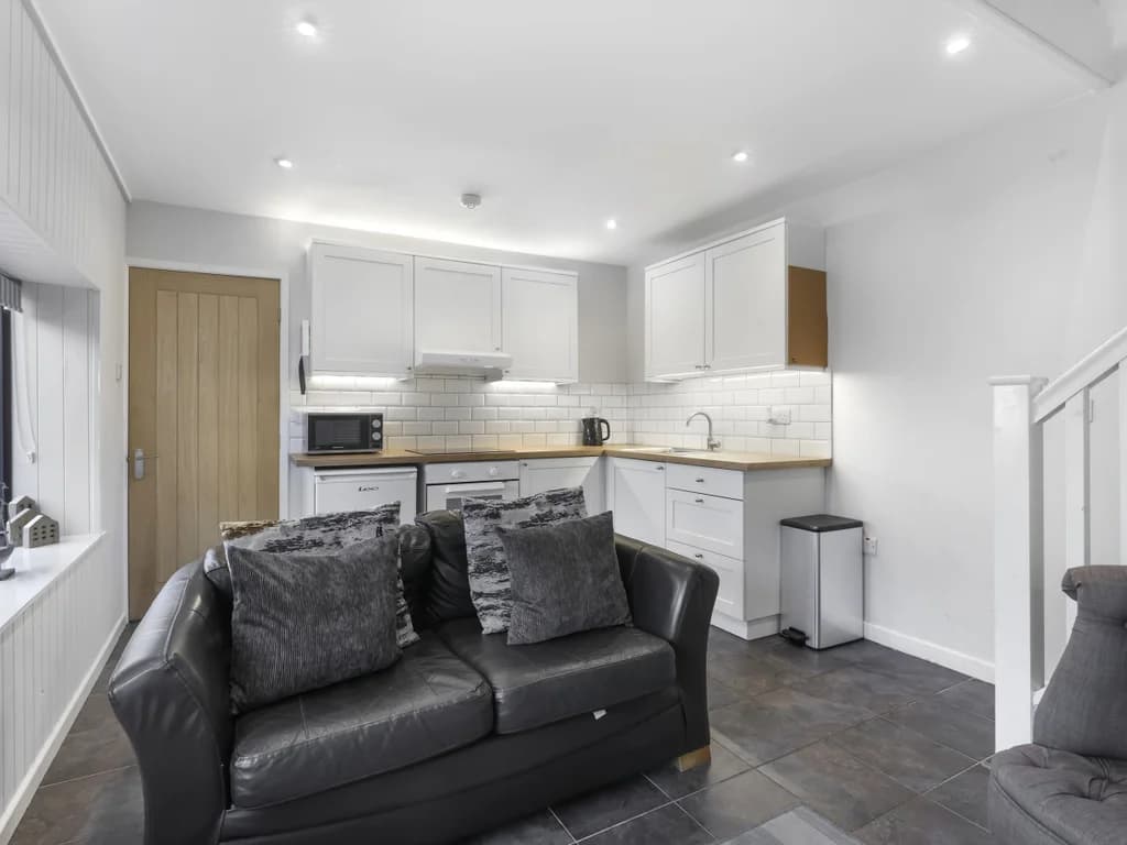 Open-plan layout connecting the lounge, dining area and kitchen