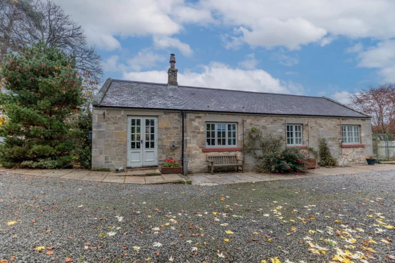 Charming cottage frontage with gravel parking and countryside setting