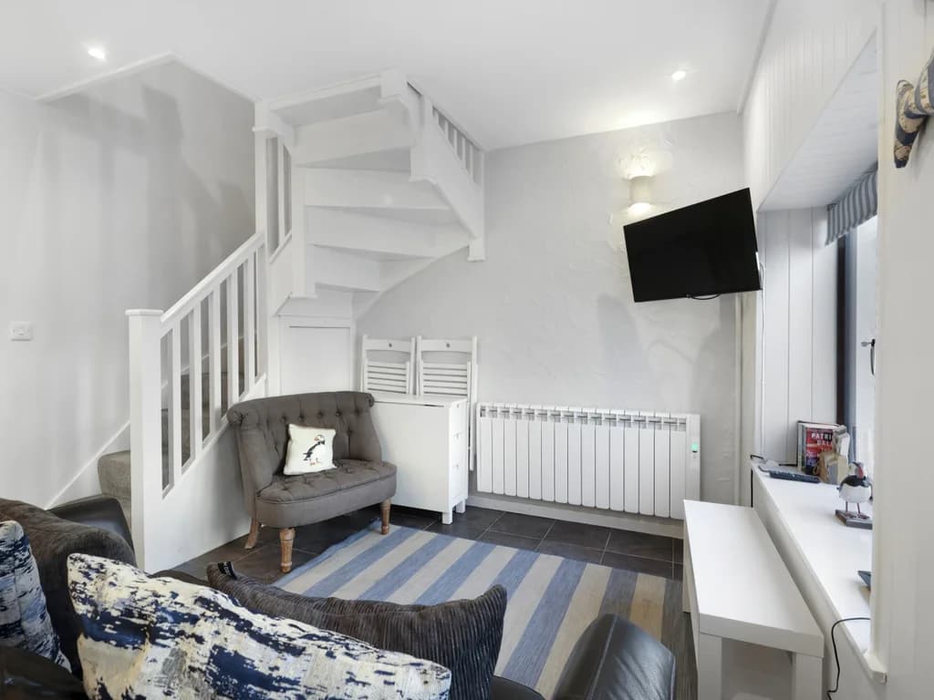 Living area with nautical décor, staircase and comfortable seating