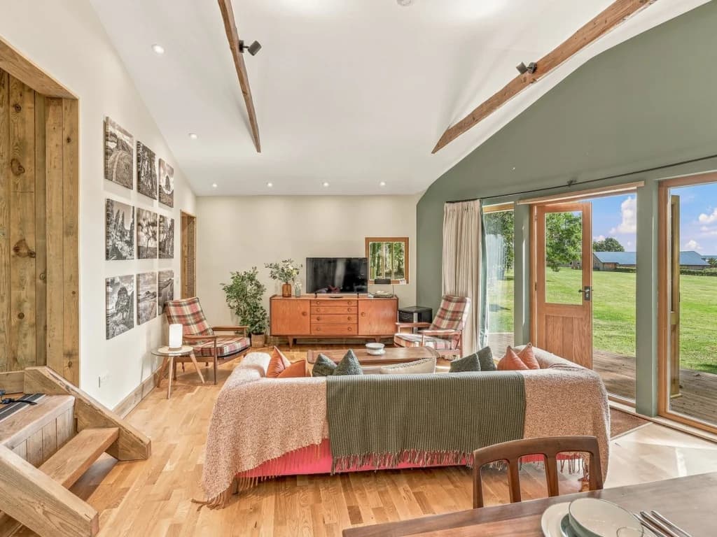 Spacious living area with Smart TV and doors opening to the grounds