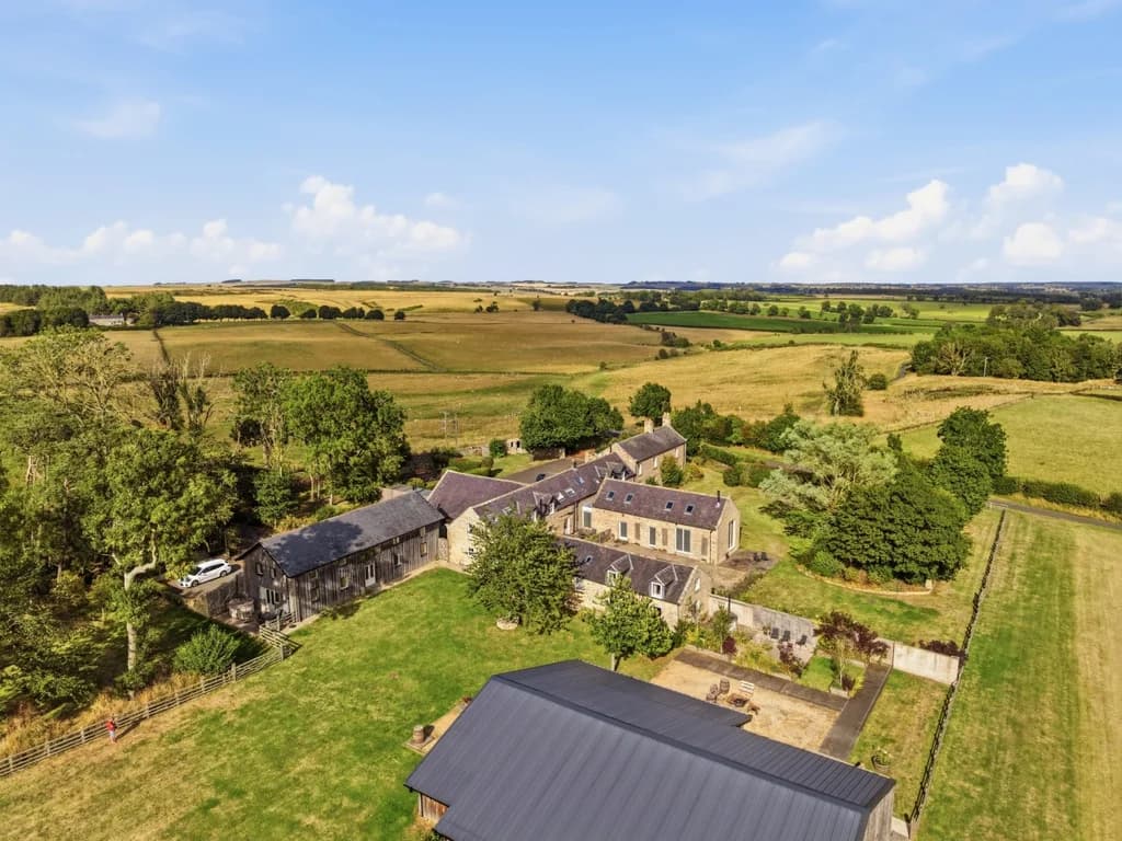 Aerial view of Drum Barn and Roses Bower amid open countryside