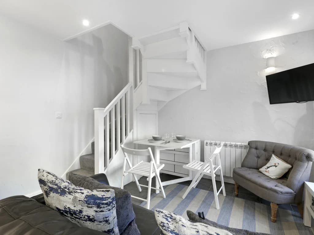 Dining nook beneath the staircase with seating for two