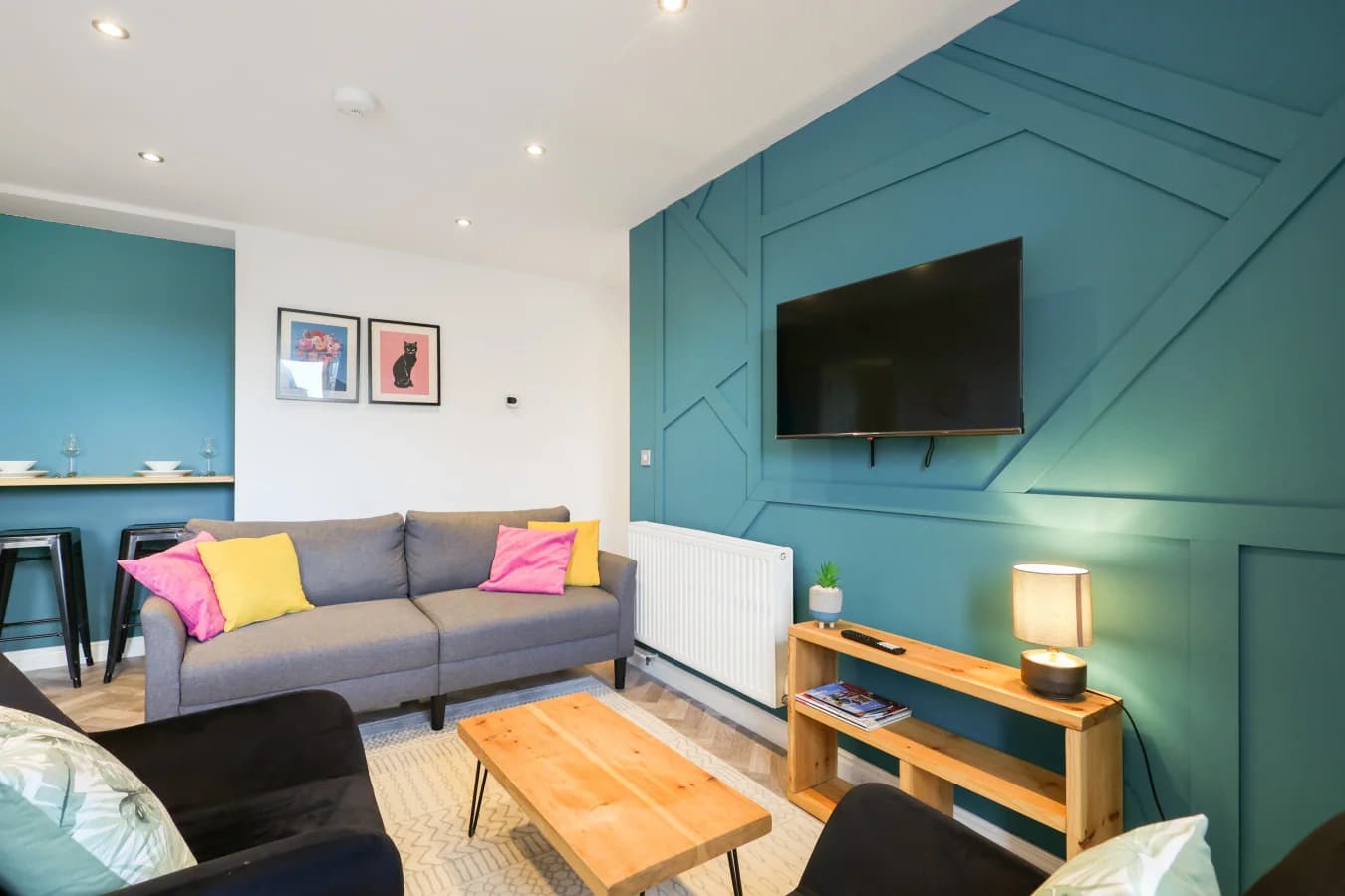 Stylish living room featuring a statement teal panelled feature wall