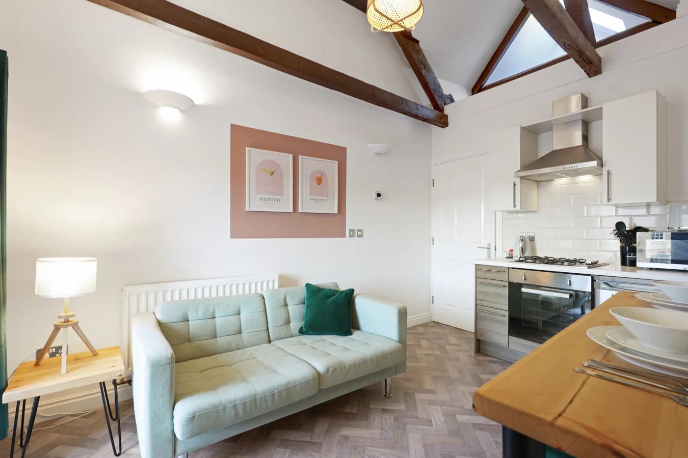 Open-plan living space with exposed beams and modern kitchen