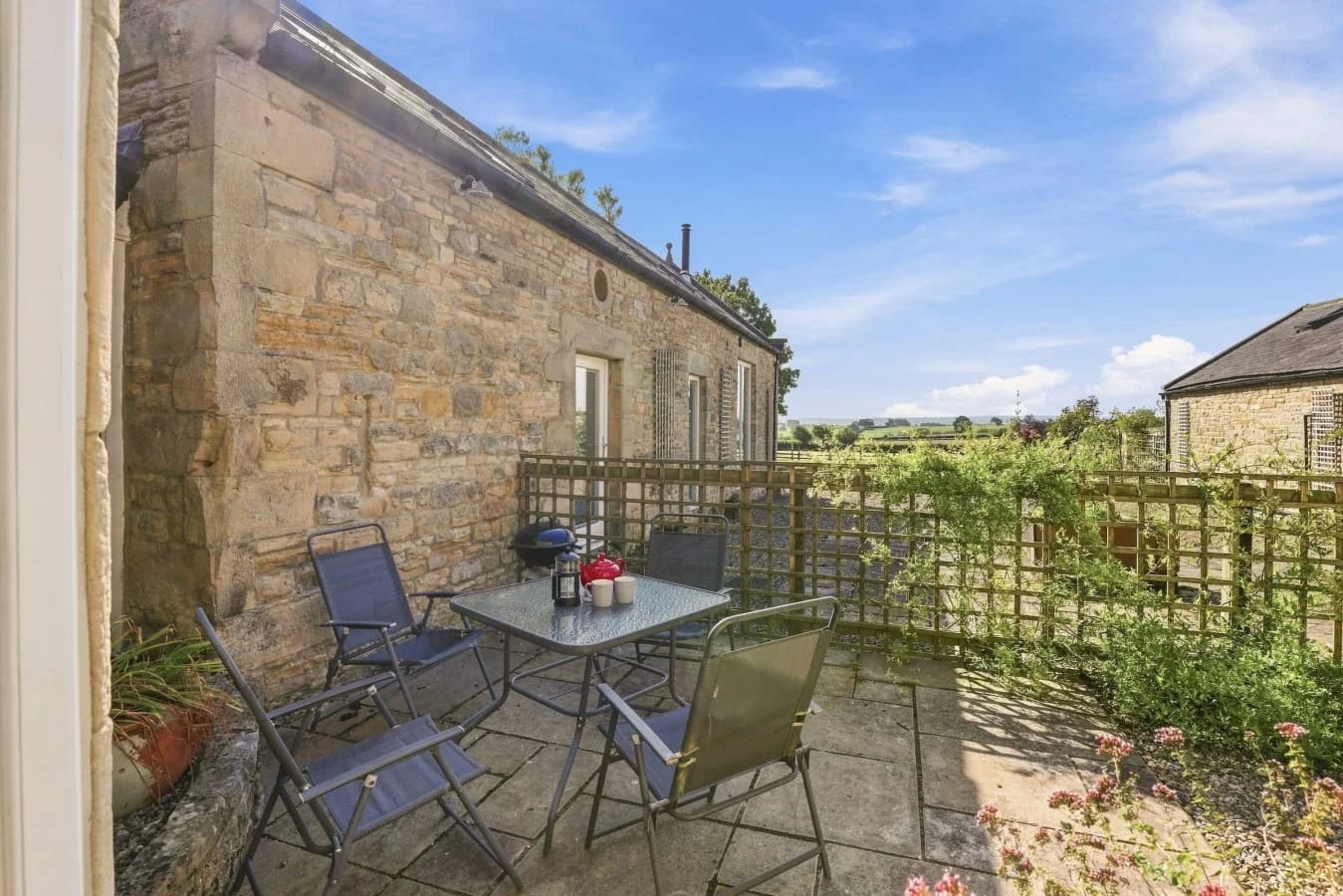 Private courtyard with outdoor seating and countryside views
