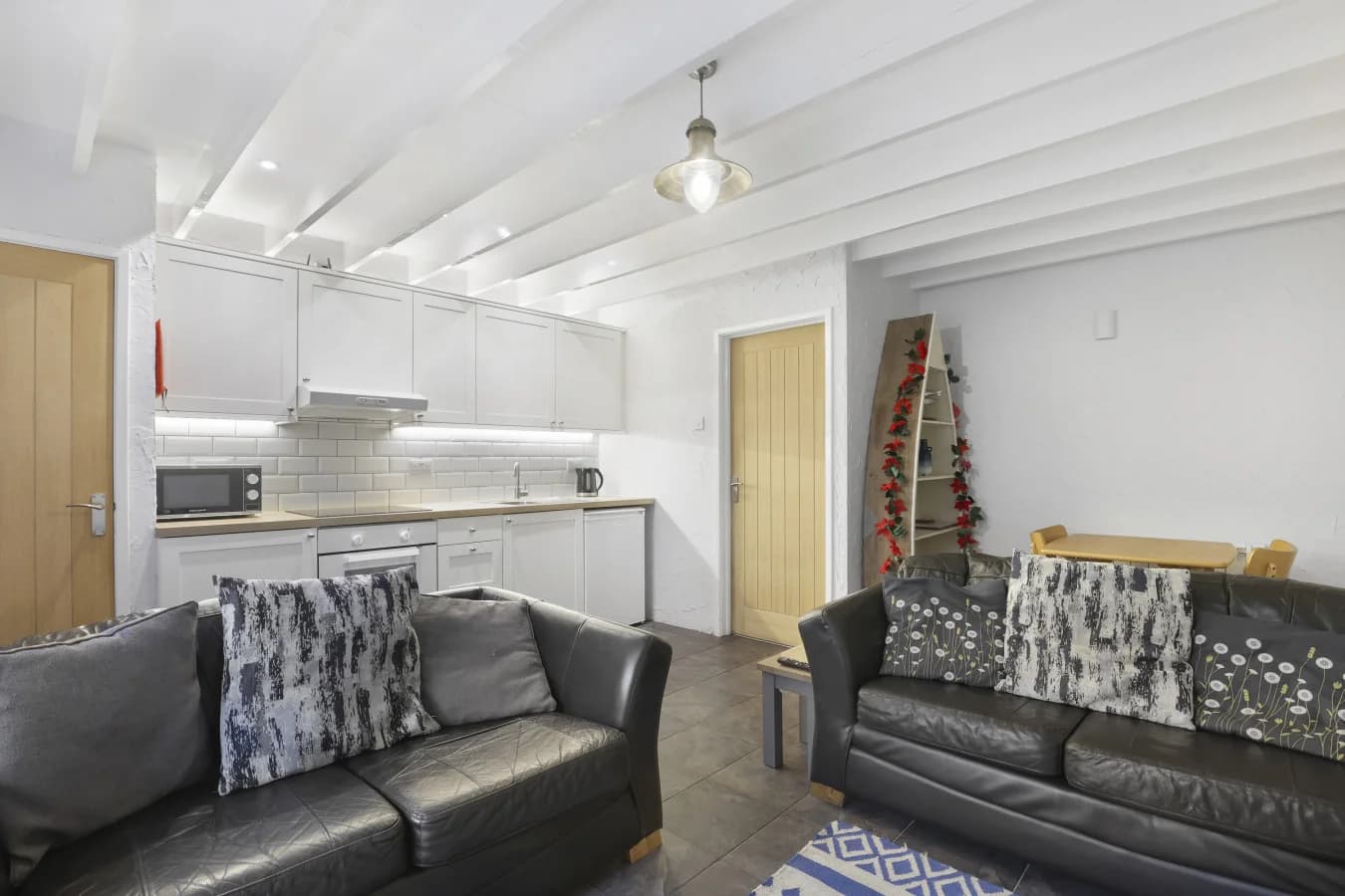 Open-plan interior with exposed ceiling beams and dining space