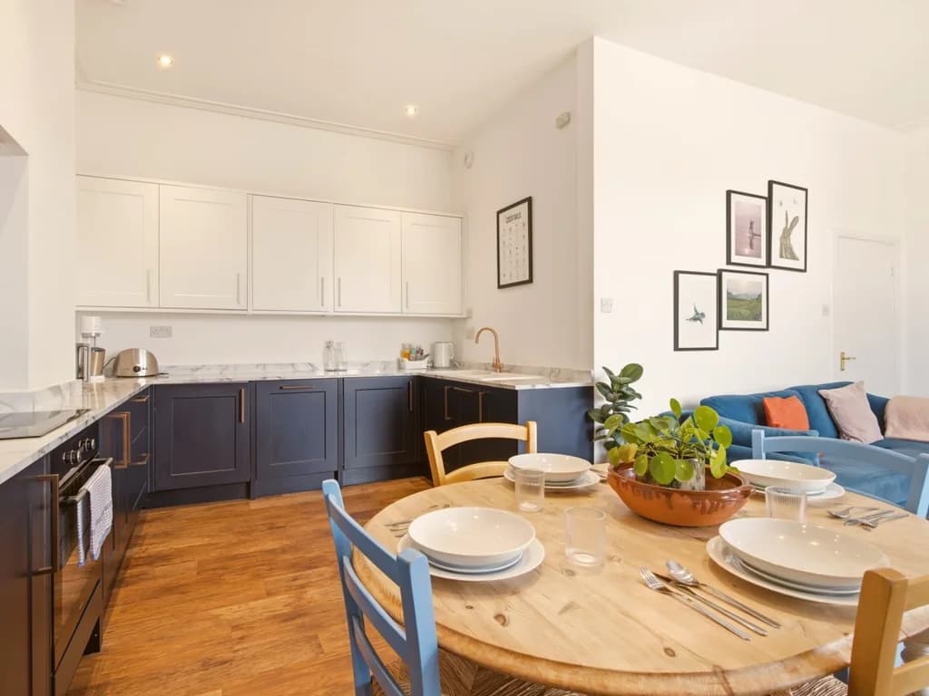Open-plan kitchen and dining area with modern cabinetry and seating.