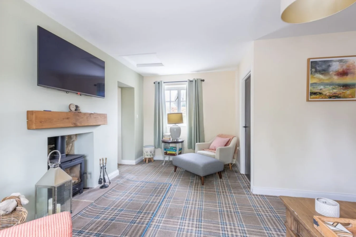 Spacious lounge with tartan carpet and cosy fireside seating