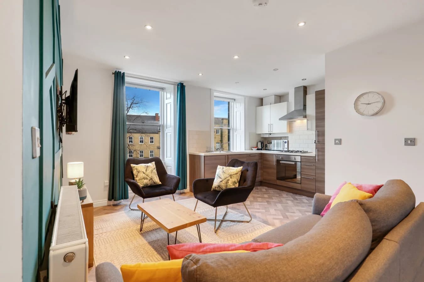 Open-plan living space with colourful accents and views over historic Alnwick