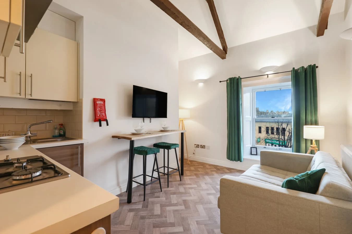Bright lounge and breakfast bar beneath vaulted Tea Warehouse beams