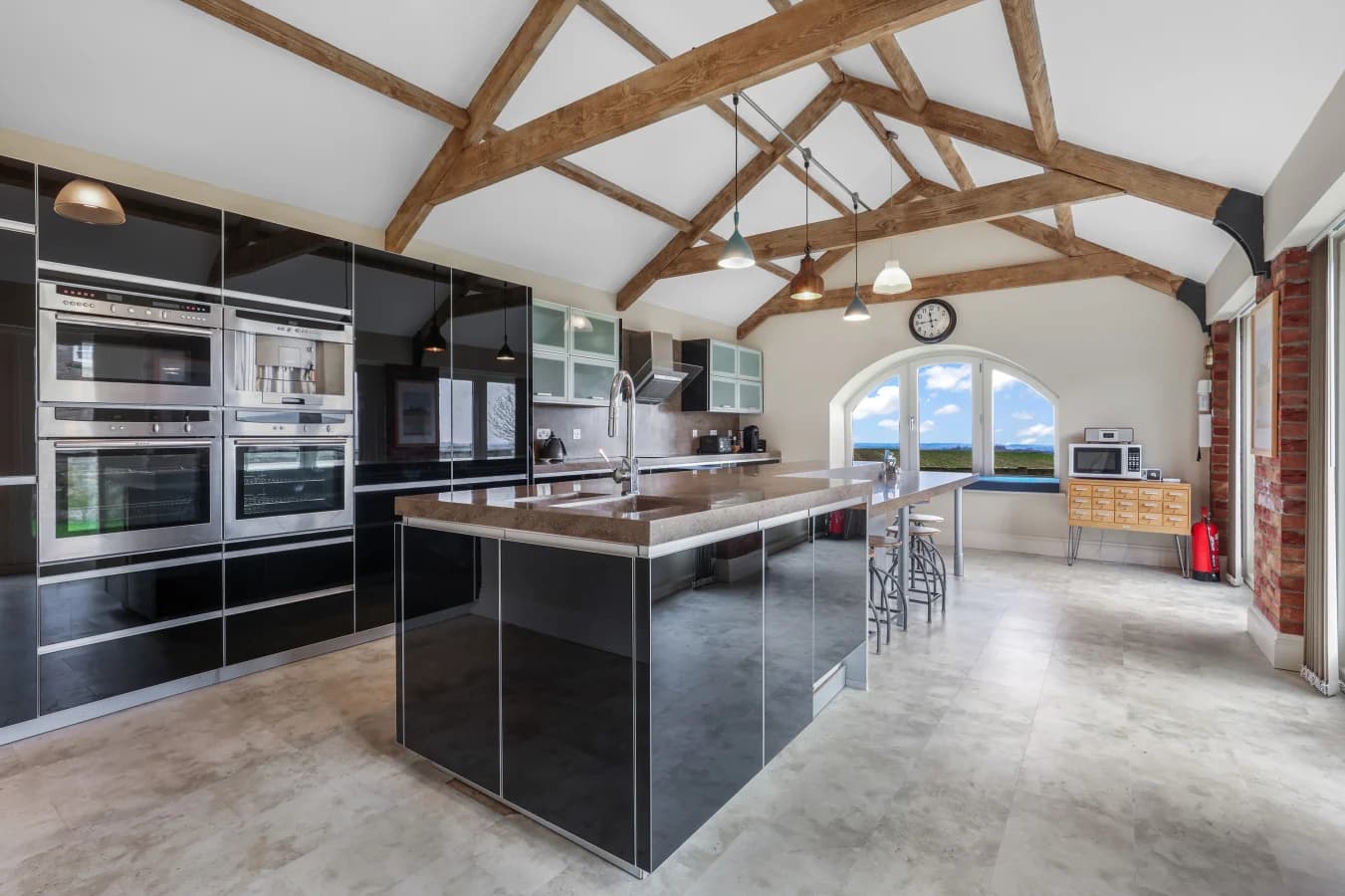 Contemporary kitchen with island, breakfast bar and vaulted ceiling