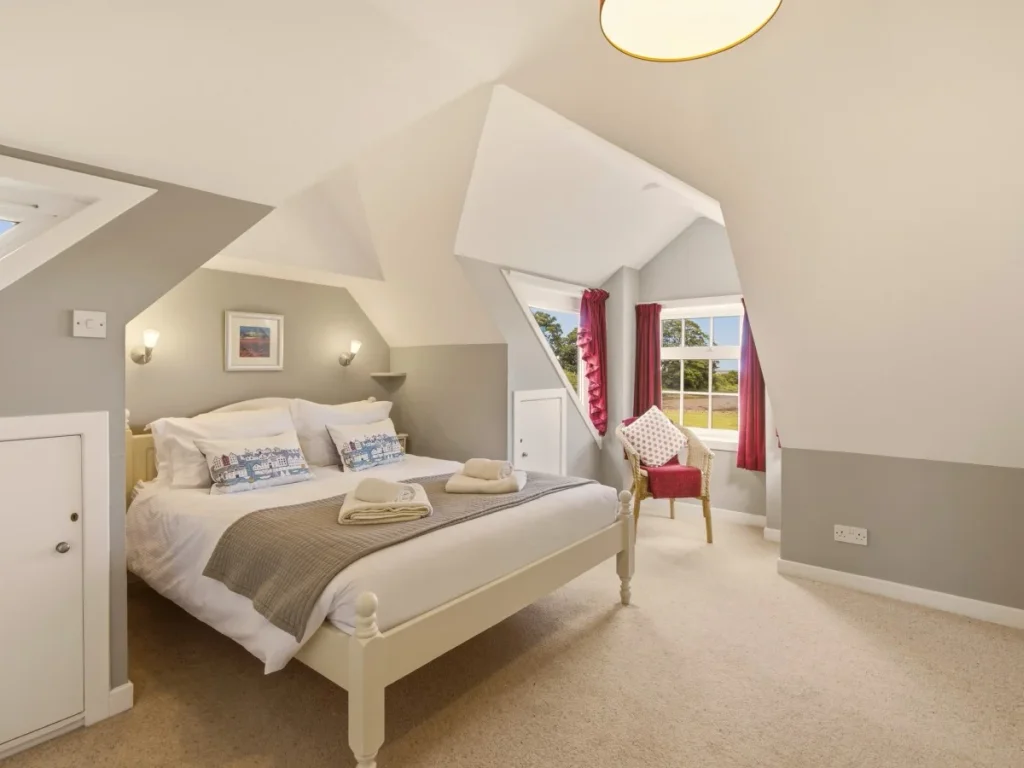 Cosy double bedroom with vaulted ceiling, countryside views and armchair seating