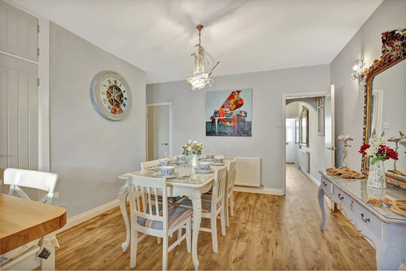 Spacious dining room with painted furniture and wood-effect flooring