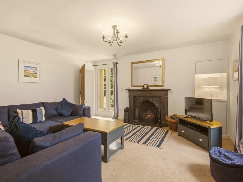 Comfortable living room with open fireplace, Smart TV and plush corner sofa