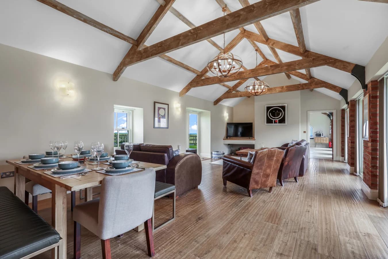 Spacious open-plan living and dining area with exposed beams