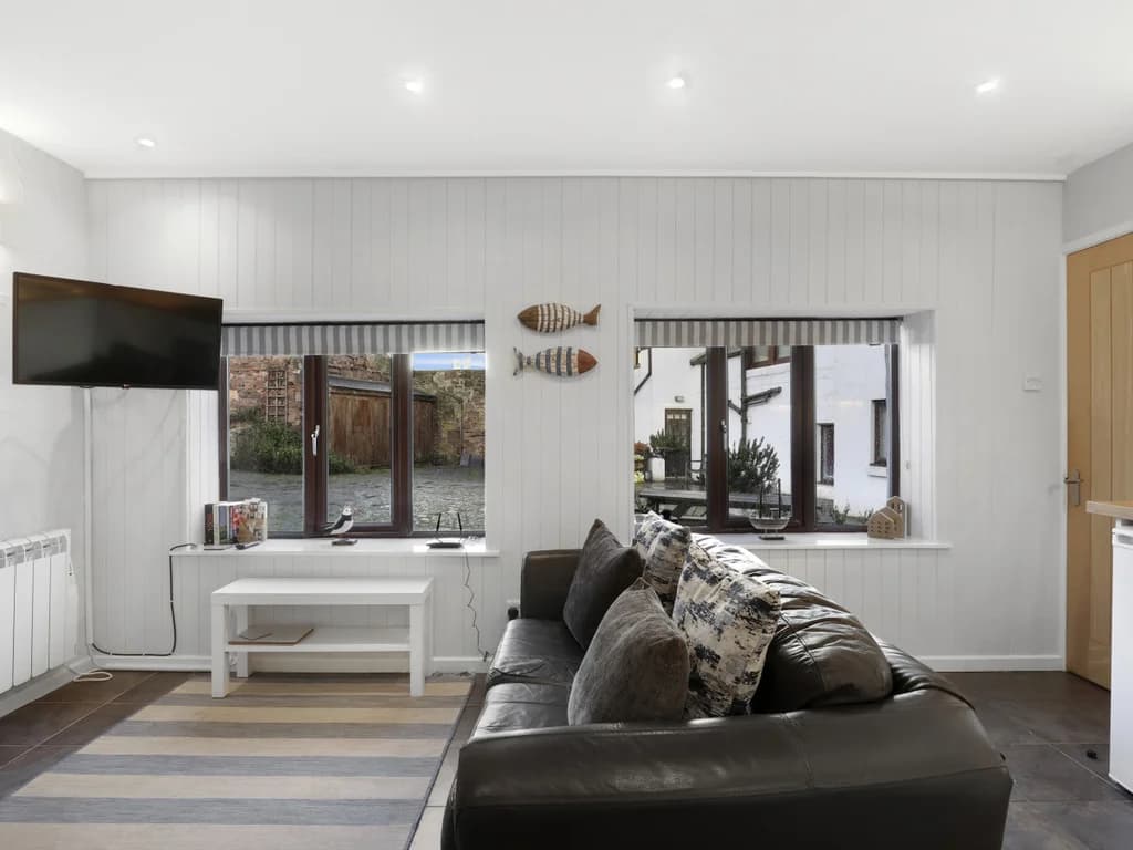Bright lounge with leather seating and views across the courtyard