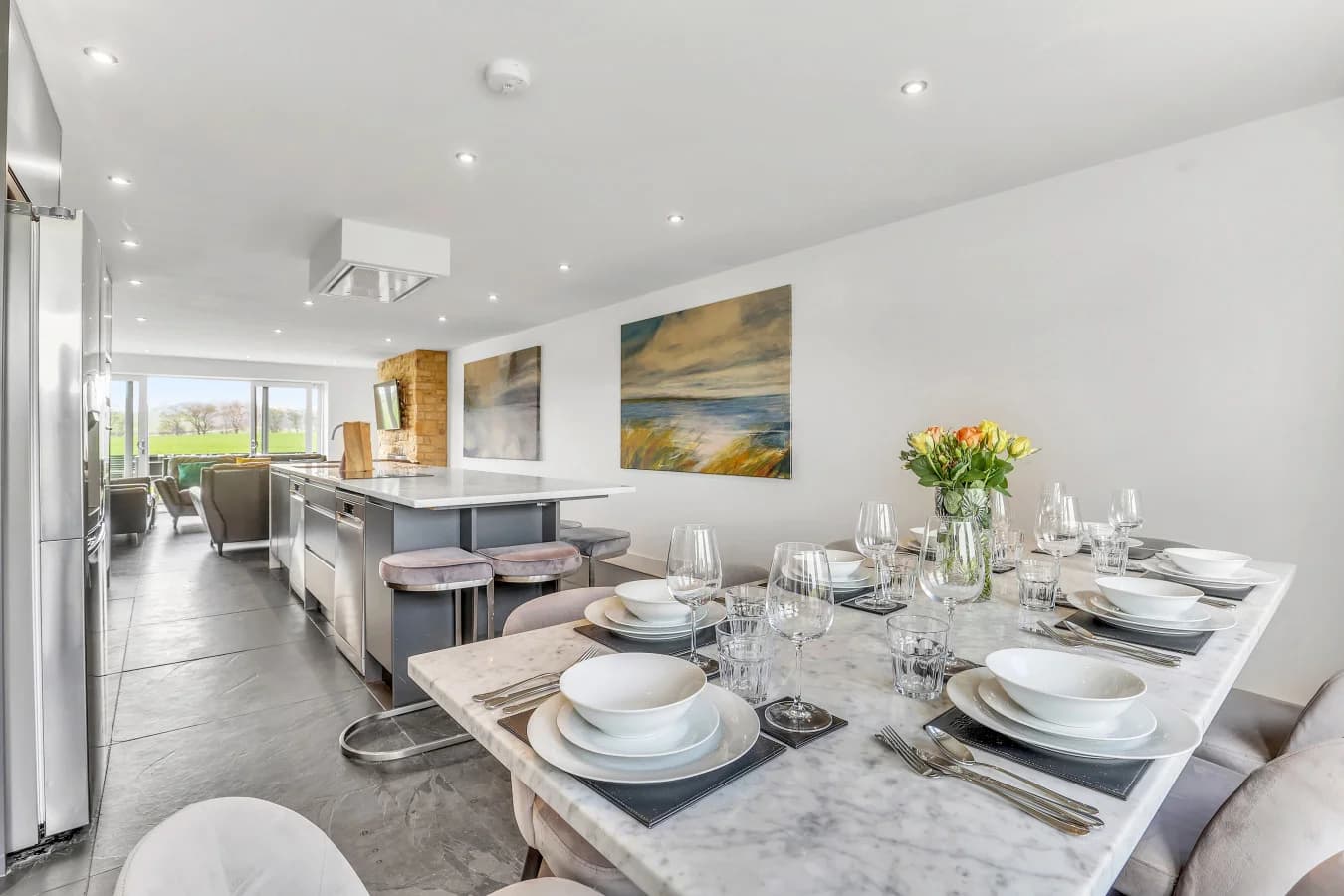 Marble dining table beside the open-plan kitchen and lounge
