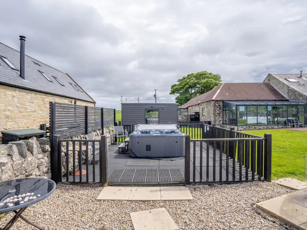 Shared hot tub area within the landscaped Dukesfield grounds