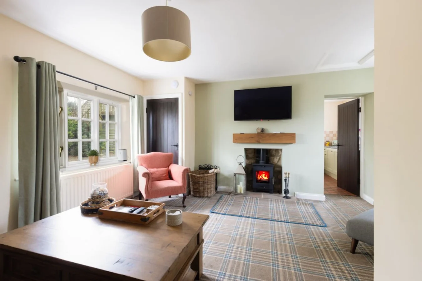 Bright sitting room with log burner, Smart TV and garden views