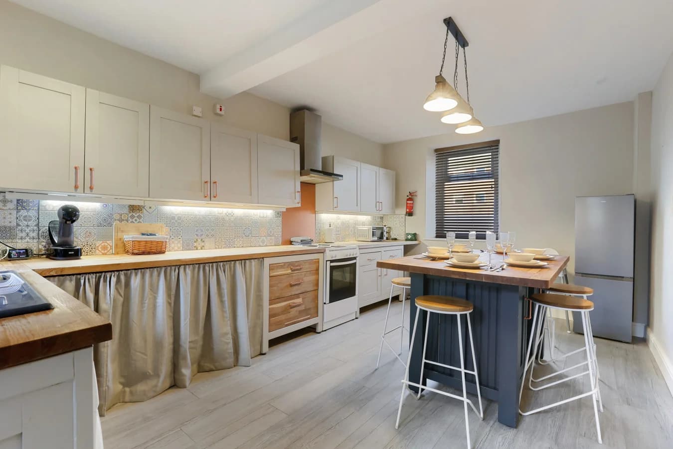 Spacious kitchen with shaker cabinetry and a central breakfast bar